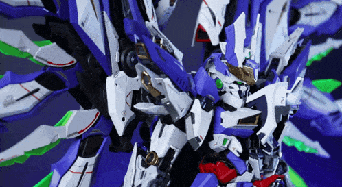 a close up of a blue and white robot with a green head