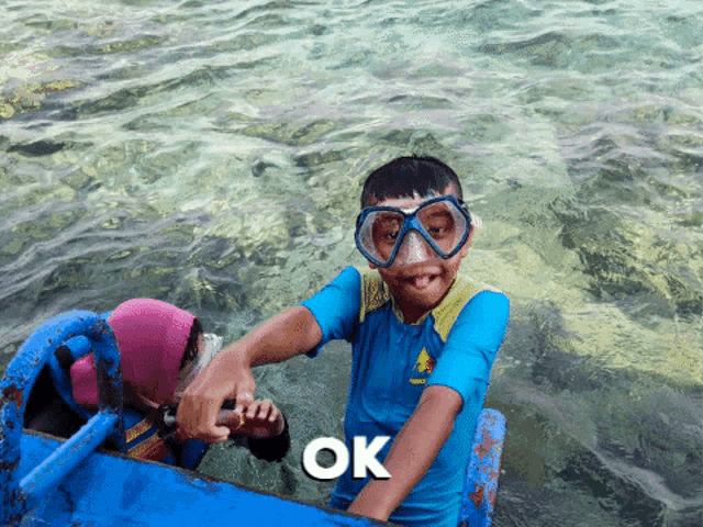 a boy wearing a blue shirt that says ' a ' on it