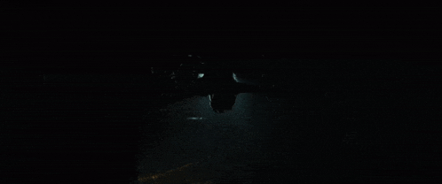 a person is flying through the air in the dark
