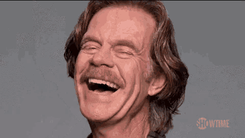 a man with long hair and a mustache is smiling for the showtime logo