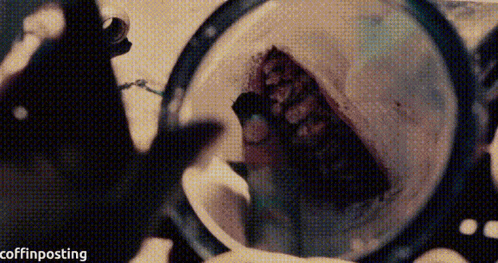 a person is looking through a magnifying glass at a person 's face .
