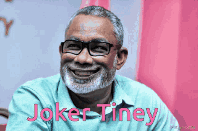 a man with a beard wearing glasses and the name joker tiney on the bottom