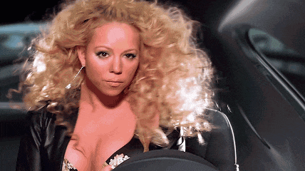 a woman with blonde curly hair and a plunging neckline
