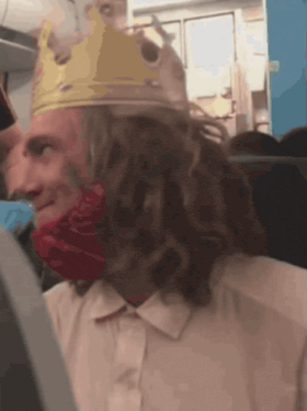 a man wearing a burger king crown and a bandana