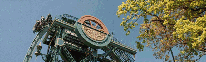 a roller coaster with a large wheel on top