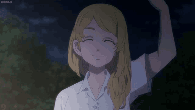 a girl with blonde hair is smiling with her eyes closed and her arm raised