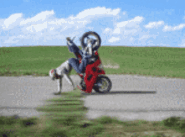 a person on a red motorcycle is doing a trick