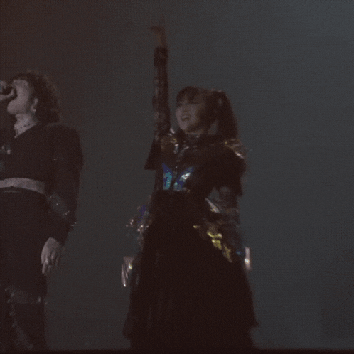 a blurry picture of a woman dancing with her arms in the air