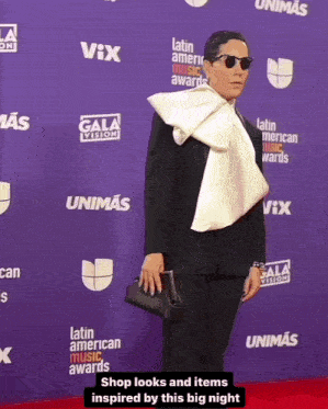 a man on a red carpet with latin american music awards written on the back
