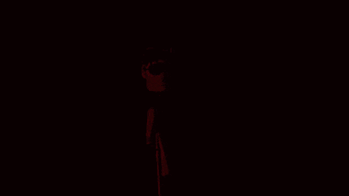 a cartoon character with horns and sunglasses in a dark room