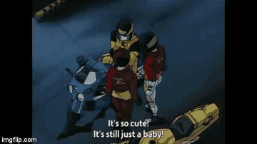 a group of motorcycle racers are standing next to each other and one of them says it 's so cute