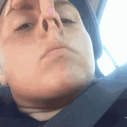 a close up of a person 's nose with a pink nail polish .