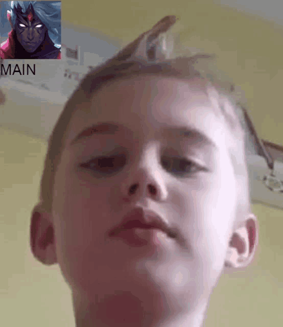 a close up of a child 's face with a picture of a man in the background with the word main below it