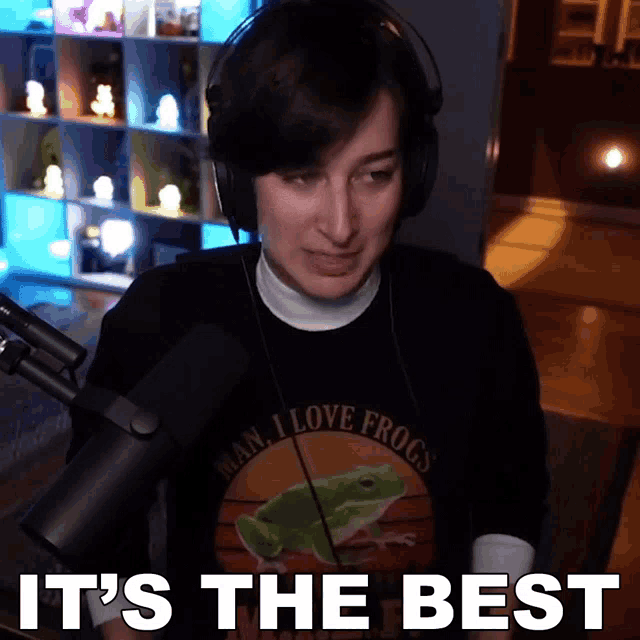 a woman wearing headphones and a shirt that says i love frogs