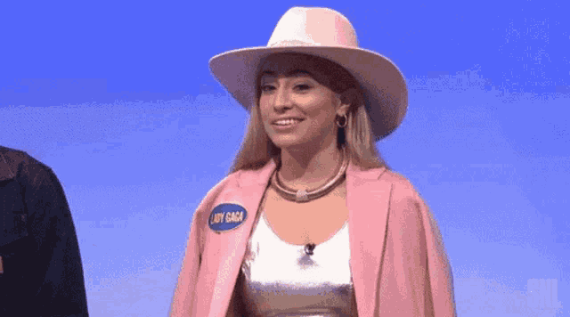 a woman wearing a pink hat and a pink jacket with a name tag that says lady gaga