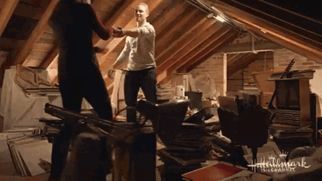 a man and a woman are dancing in an attic with the words hallmark entertainment visible