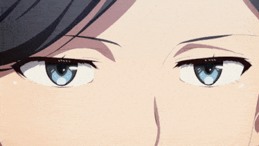 a close up of a person 's eyes with a slight smirk on their face