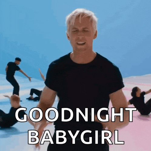 a man in a black shirt says goodnight babygirl in front of a group of dancers