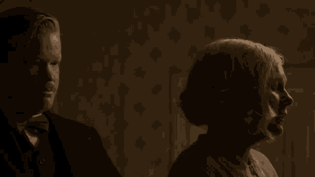 a man and woman are standing next to each other
