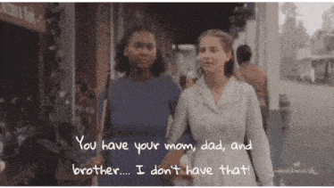 two women are walking down a street with the words " you have your mom dad and brother ... i don 't have that "