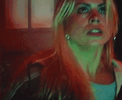 a close up of a woman 's face with a surprised expression on her face .