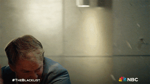 a man in a suit with the blacklist written on the bottom right