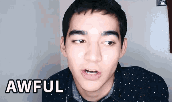 a young man with a polka dot shirt says awful in front of his face