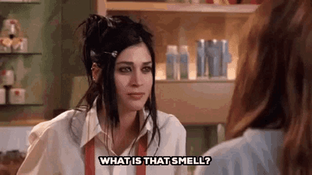 a woman is talking to another woman in a store and asking her what is that smell .