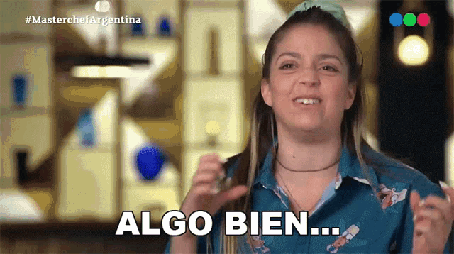 a woman in a blue shirt says " algo bien " in spanish