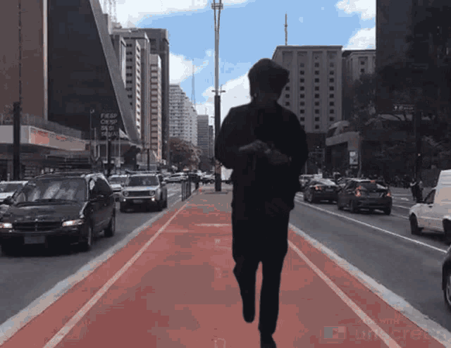a person walking down a street with a youtube logo on the bottom