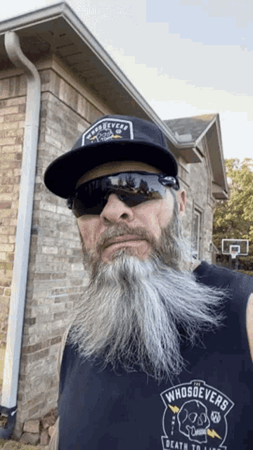 a man with a long beard wearing sunglasses and a hat that says whosoevers