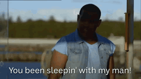a man standing in front of a sign that says " you been sleepin ' with my man "