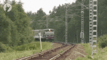 a train is going down the tracks in the woods with a sign that says ' a ' on it
