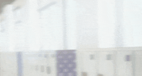 a girl in a school uniform is walking down a hallway and smiling