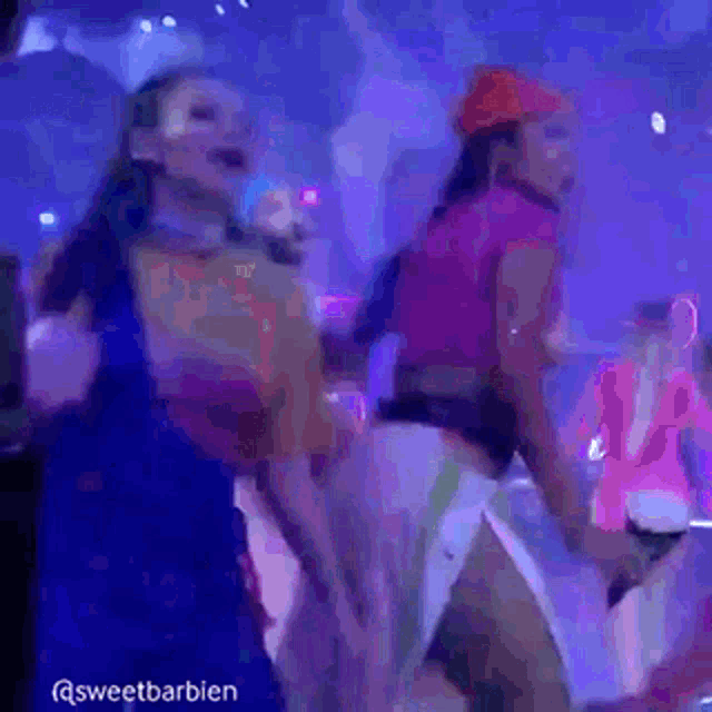 two women are dancing in a club with the words sweetbarbien in the corner