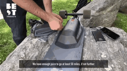 a man is working on a skateboard with the words we have enough juice to go at least 50 miles if not further on the bottom