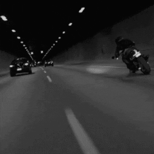 a man is riding a motorcycle in a tunnel .