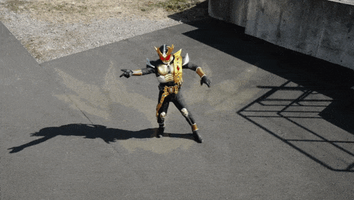 a man in a black and gold superhero costume is standing on a road