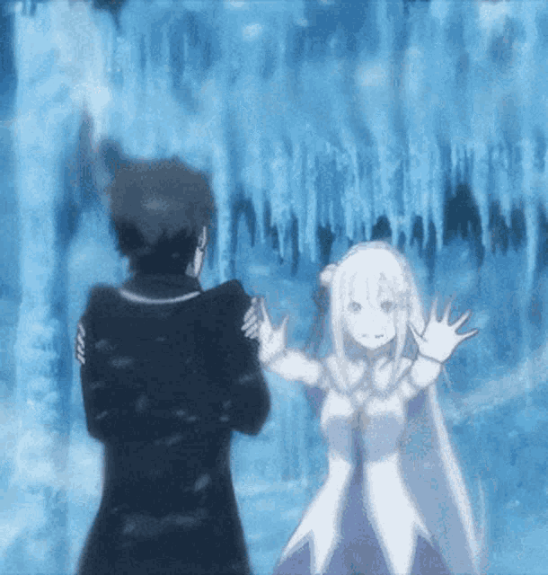 a man and a woman are standing next to each other in front of a waterfall