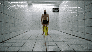 a man stands in a room with a sign that says level 6 pissa