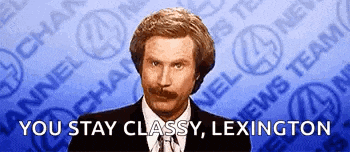 a man in a suit and tie is standing in front of a blue background with the words `` you stay classy lexington '' .