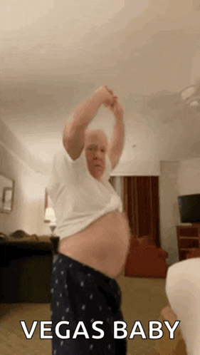 an older man is dancing in a living room with the words vegas baby written on the bottom