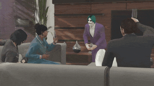 a group of people sitting on a couch with a man in a purple suit