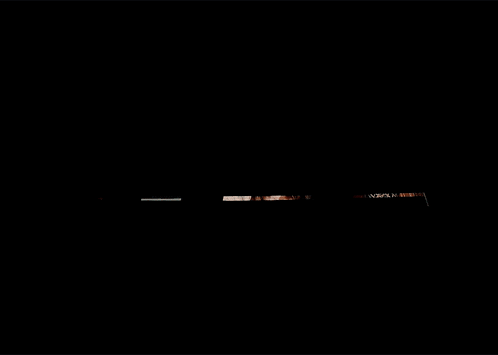 a woman is standing in a dark room looking up at the camera