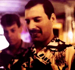 a man with a mustache is wearing a shirt that says ' a ' on it .