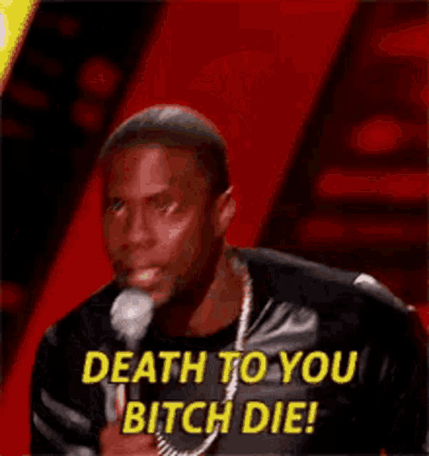 a man is holding a microphone in his hand and says `` death to you bitch die '' .