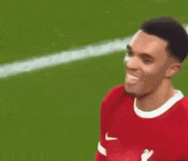 a close up of a soccer player 's face on a field .