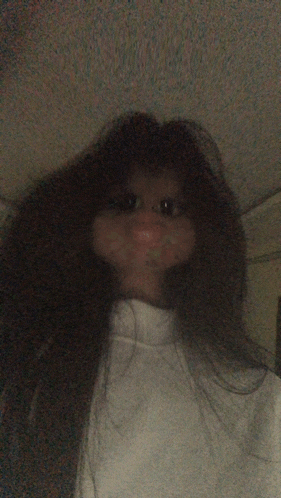 a woman with long hair is wearing a white sweater