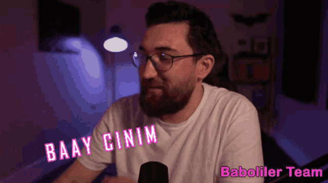 a man wearing glasses and a white shirt says baay cinima
