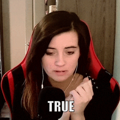 a woman is sitting in a red chair with a microphone in front of her and the word true is on her face .